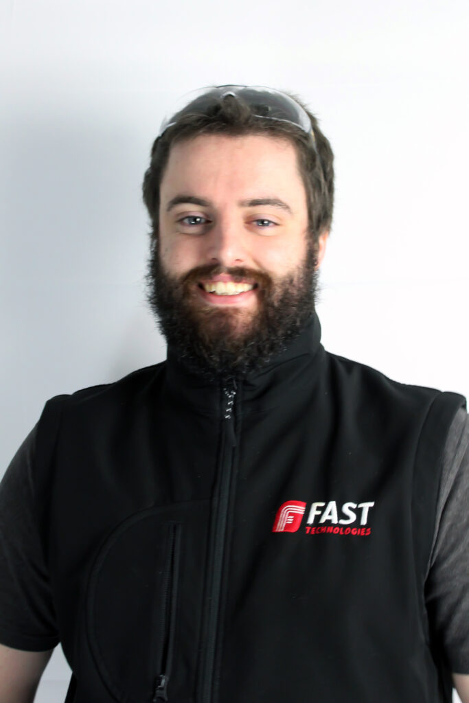 A portrait photo of a FAST employee smiling to the camera.